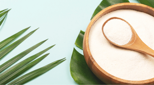 collagen powder in bowl on green leaves featured