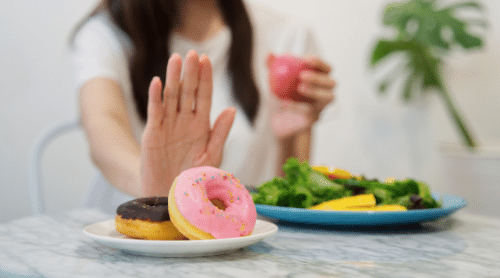 woman saying no to junk food featured image