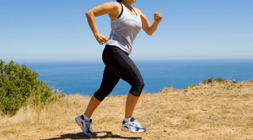 woman running outside near ocean featured