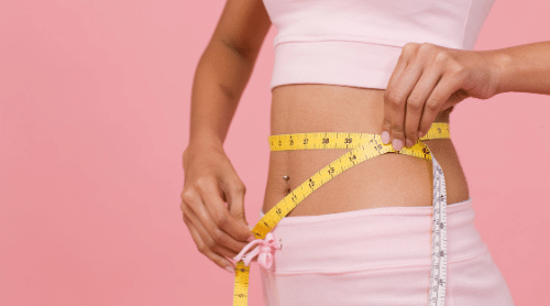 woman with measuring tape around waist featured rapid weight loss