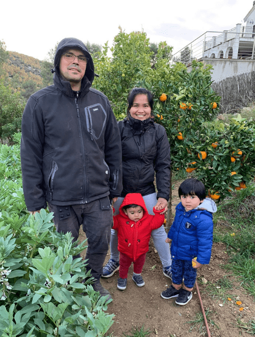 Julai and family in the garden - Julai, husband and their two small children